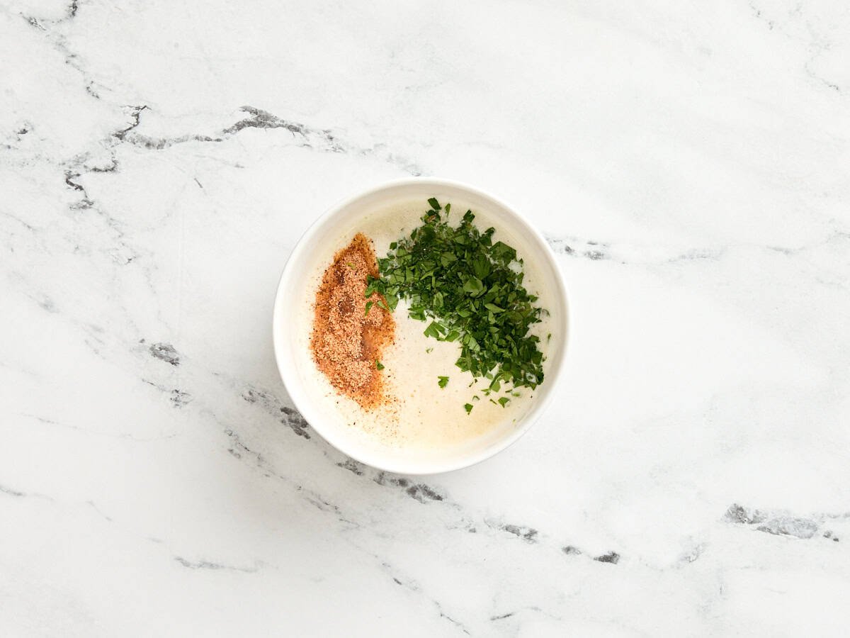 Cajun seasoning and fresh parsley added to melted butter.