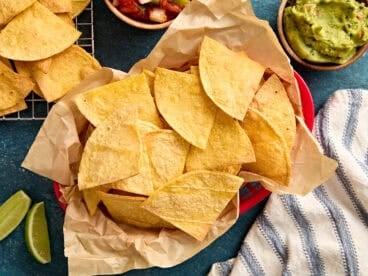 Overhead view of air fryer tortilla chips in a basket.