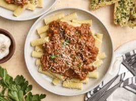Overhead view of a plate of bolognese sauce and pasta.