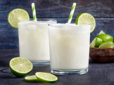 Side view of two glasses of homemade Brazilian lemonade.