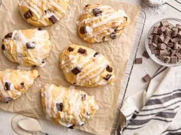 Overhead view of homemade chocolate chip sourdough scones on a parchment lined wire rack.