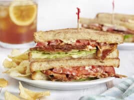 Side view of a classic blt sandwich on a plate.