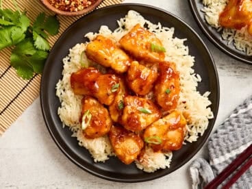 Overhead view of firecracker chicken on a bed of rice.