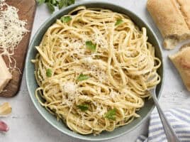 Overhead view of a plate of fettuccine alfredo with a fork.