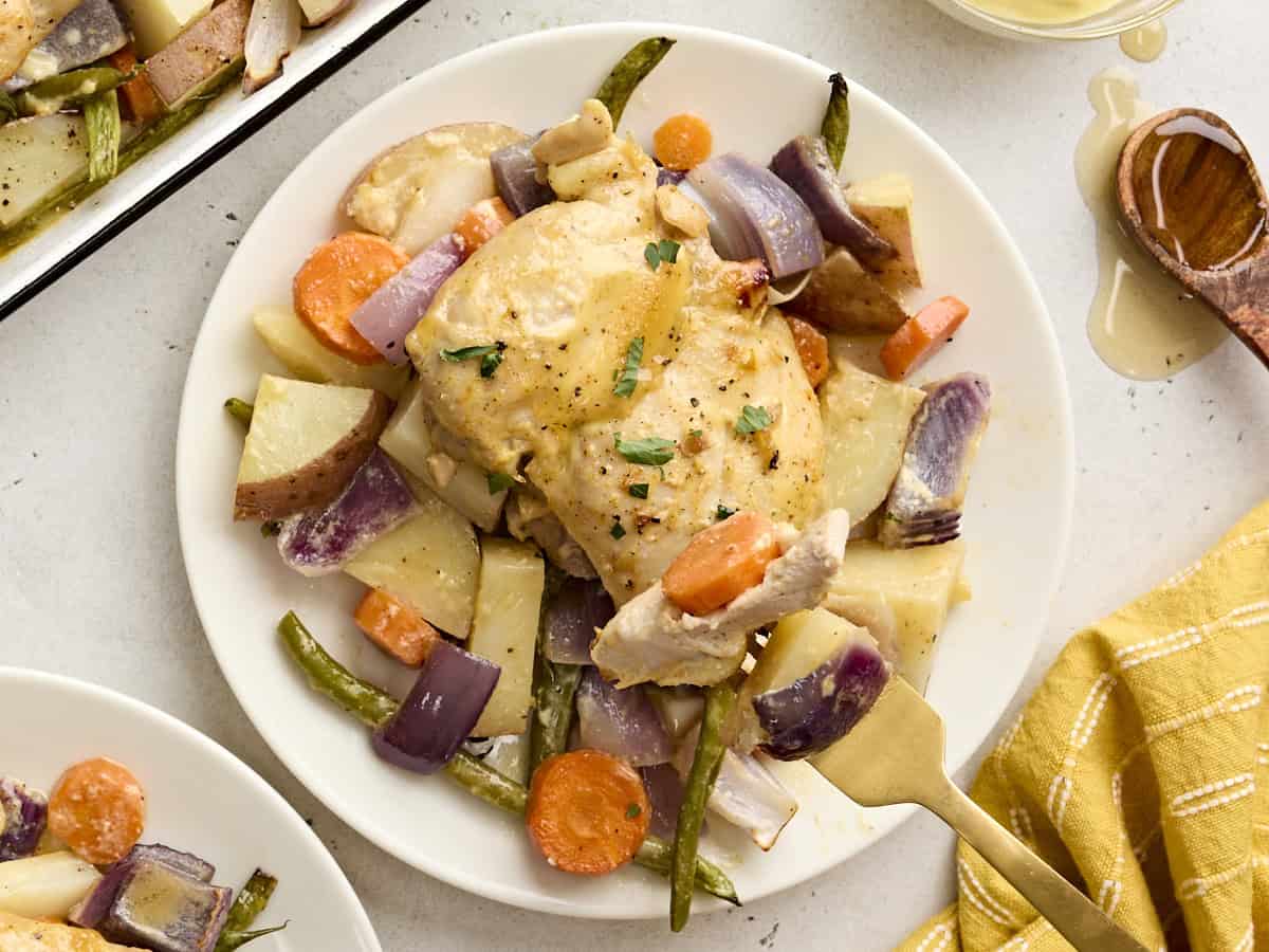 Overhead view of honey mustard chicken with vegetables on a plate.