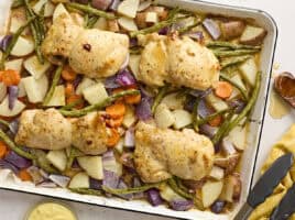 Overhead view of sheet pan honey mustard chicken with veggies.