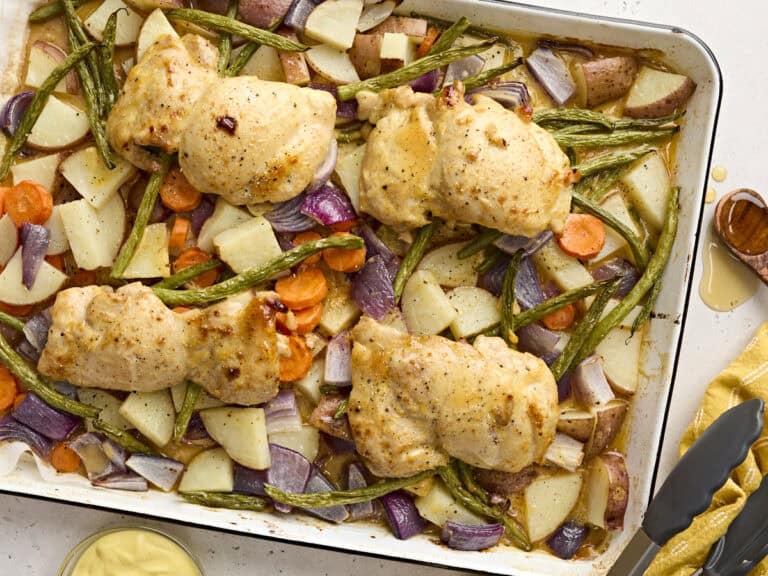 Overhead view of sheet pan honey mustard chicken with veggies.