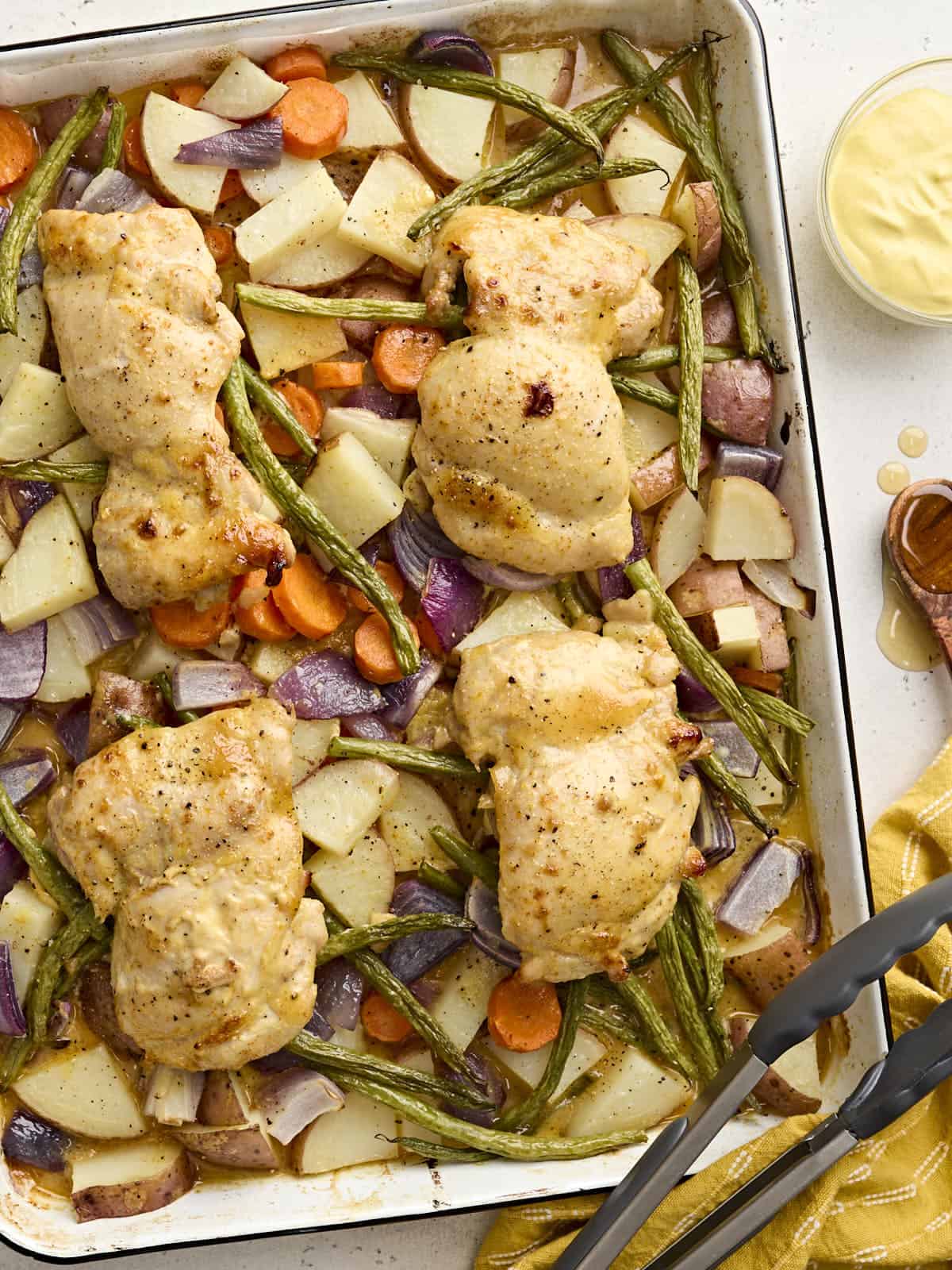 Overhead view of sheet pan honey mustard chicken with veggies.