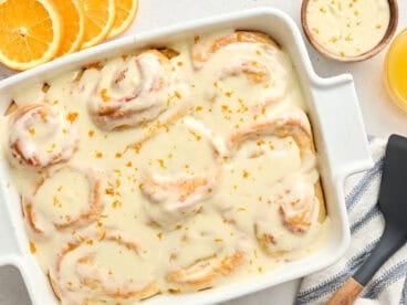 Overhead view of homemade orange rolls in a baking dish.