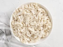 Overhead view of a bowl of pulled chicken.
