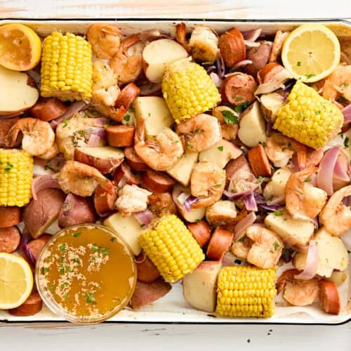 An overhead view of a shrimp boil on a sheet pan.