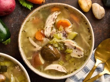Overhead view of a bowl of homemade stone soup.